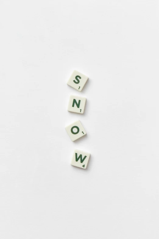 the word snow spelled in scrabbles on a white surface, by Emma Andijewska, trending on unsplash, visual art, #green, four, icon, stew