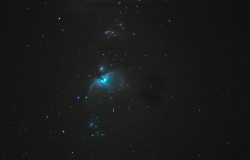 a cluster of stars in the night sky, a hologram, flickr, light and space, very dark with green lights, shot with sony alpha 1 camera, blue fireball, 2022 photograph