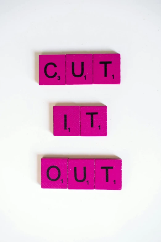 pink blocks spelling out cut it out on a white surface, an album cover, ((purple)), blackout, cutout, without text