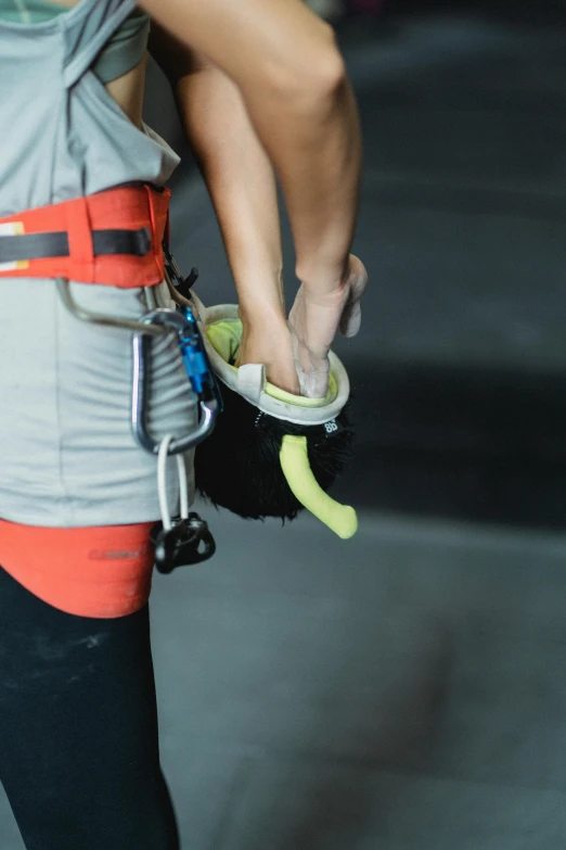 a woman holding a tennis racquet and a tennis ball, by Jessie Algie, pexels contest winner, rock climbing, carrying a tray, worksafe. instagram photo, low detail