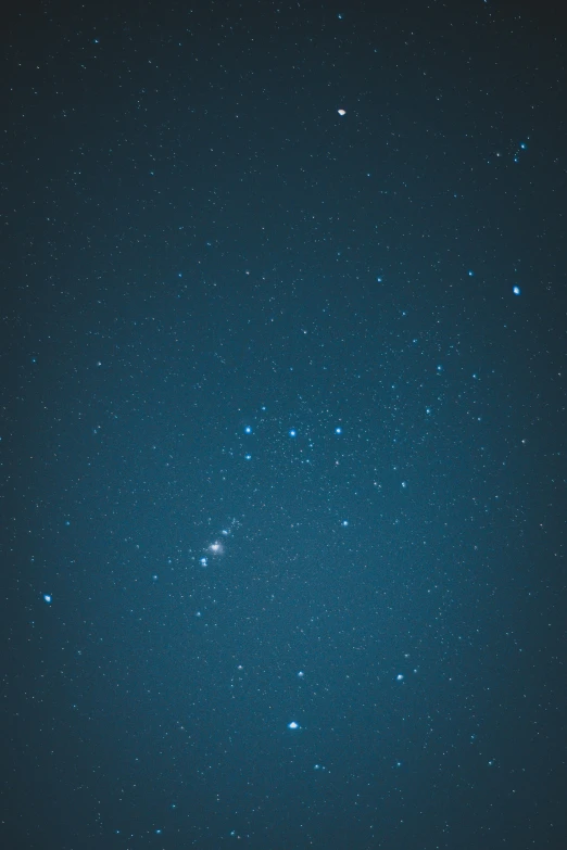 a blue sky filled with lots of stars, a microscopic photo, by David Martin, taken with sony alpha 9, cyan, dark, low quality grainy