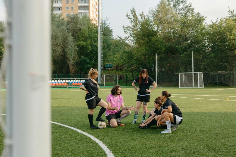 a group of women sitting on top of a soccer field, by Attila Meszlenyi, pexels contest winner, danube school, calmly conversing 8k, standing in midground, 15081959 21121991 01012000 4k, complex scene