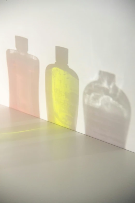 a group of bottles sitting on top of a counter, by Jan Rustem, conceptual art, sunlight filtering through skin, translucent pastel panels, clear silhouette, toothpaste refinery