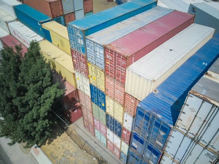 a bunch of shipping containers stacked on top of each other, an album cover, unsplash, chile, drone footage, rhys lee, ariel perez