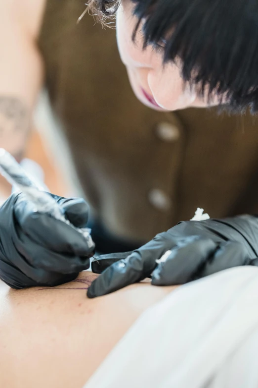 a woman getting a tattoo on her arm, by Jason Felix, trending on unsplash, process art, asian male, panoramic shot, mai anh tran, low detail