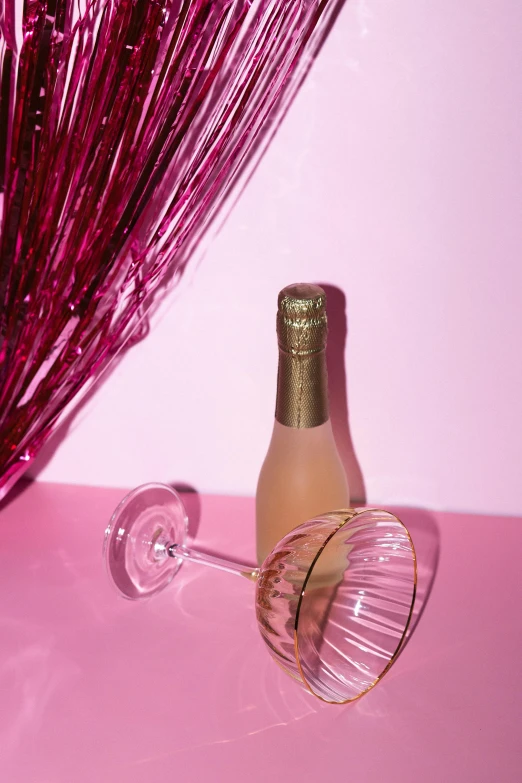 a bottle of champagne next to a wine glass, pink background, millennial vibes, shimmer detailed, blushing