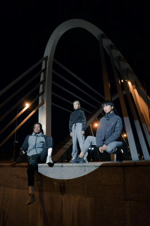 a group of people sitting on top of a bridge, by Jang Seung-eop, realism, band promo photo, wearing a track suit, moonlight grey, (3 are winter