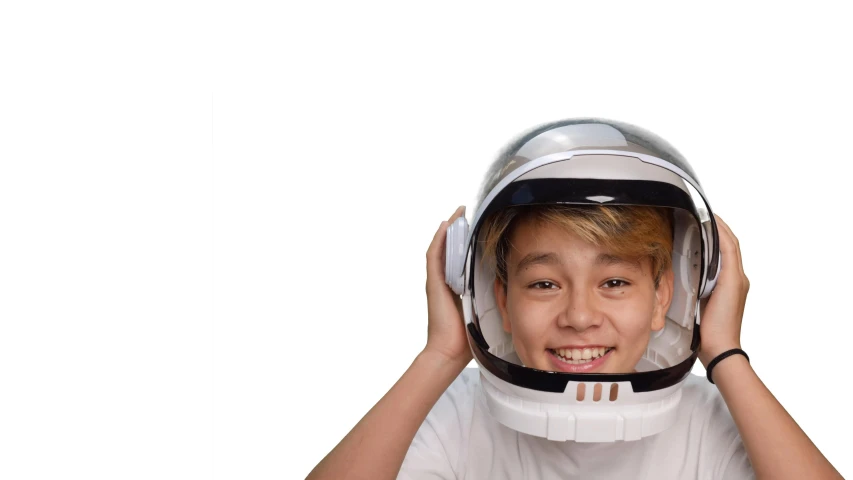 a young boy wearing a helmet on top of his head, shutterstock, fantastic realism, wearing an astronaut helmet, whitespace, pewdiepie, smiling for the camera
