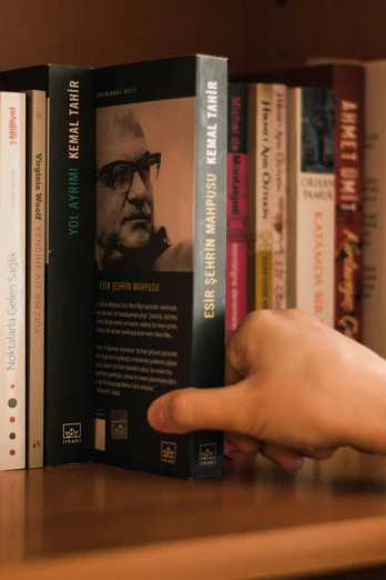 a person reaching for a book on a shelf, a digital rendering, inspired by Karl Matzek, unsplash, hyperrealism, closeup portrait shot, arthur clarke, with pointing finger, cover shot