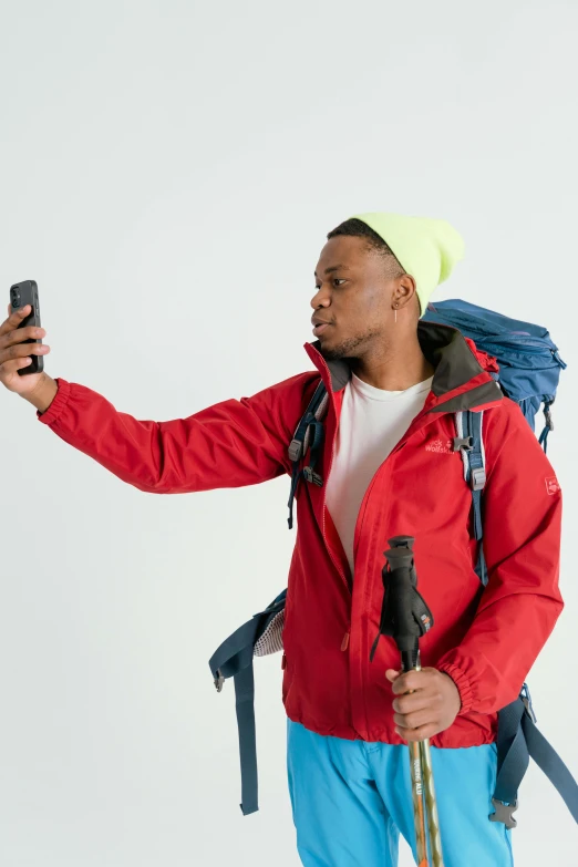 a man taking a selfie with his cell phone, trending on pexels, visual art, wearing red jacket, wearing adventure gear, mkbhd, but minimalist