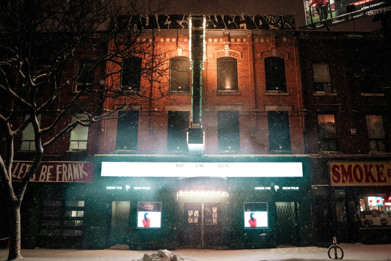a fire hydrant sitting in the snow in front of a building, by Peter Brook, renaissance, marquee, hozier, multiple lights, theater