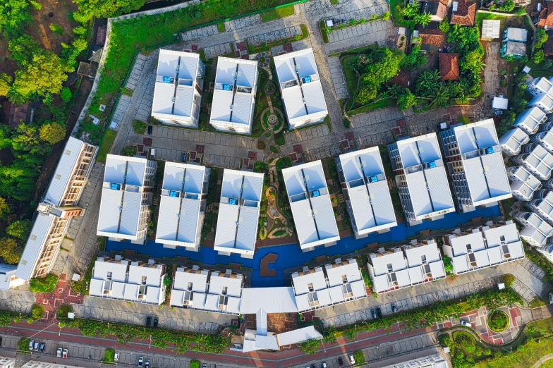 an aerial view of a city with lots of buildings, by Daniel Lieske, shutterstock, concrete housing, bali, symmetry, modular