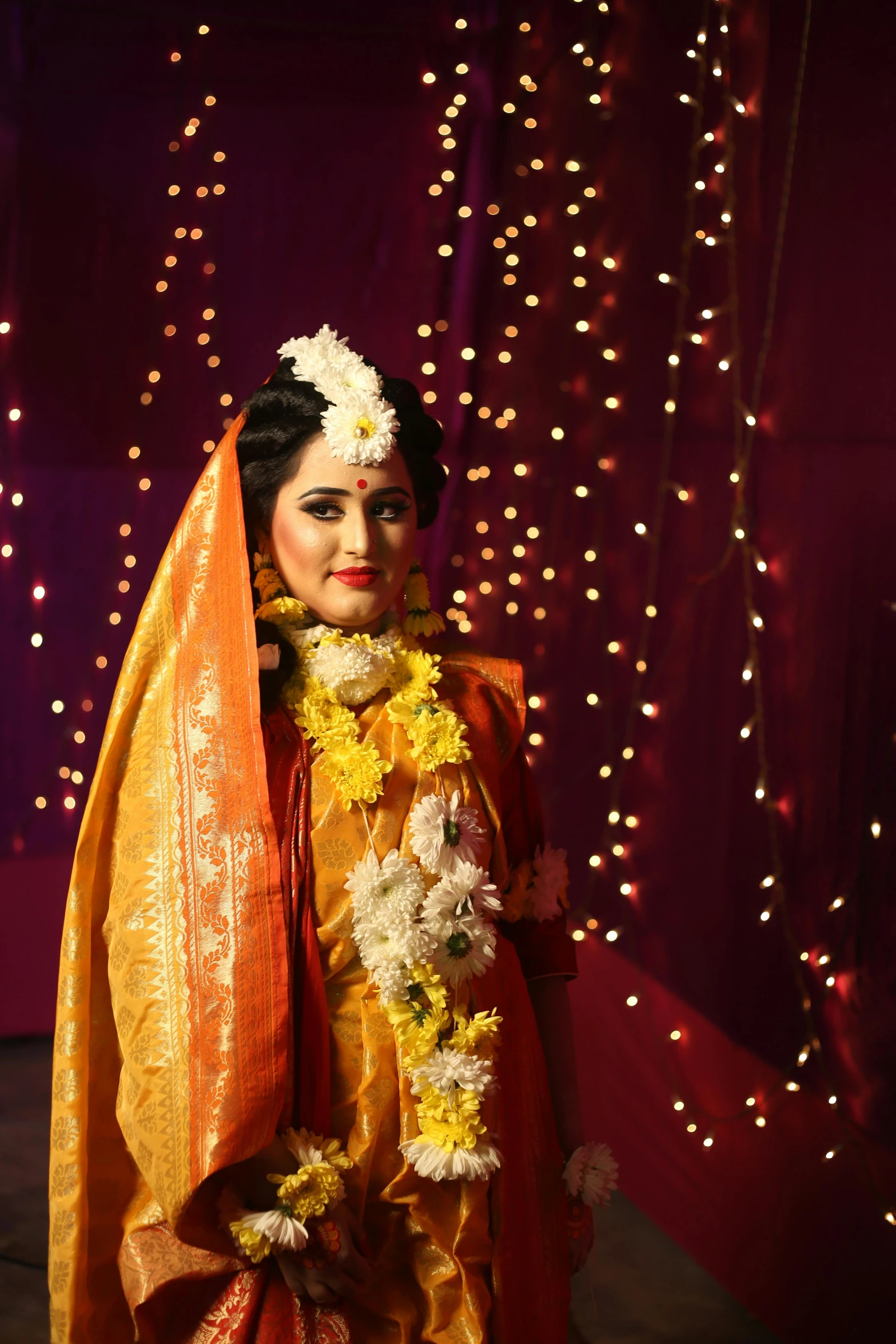 a woman dressed in an orange and yellow outfit, by Sudip Roy, bride, slide show, lights on, ((portrait))