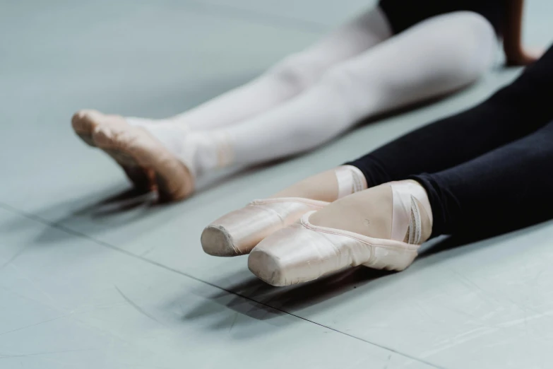 a pair of ballet shoes sitting on the floor, by Elizabeth Polunin, pexels contest winner, arabesque, closeup of arms, panels, thumbnail, studio shot