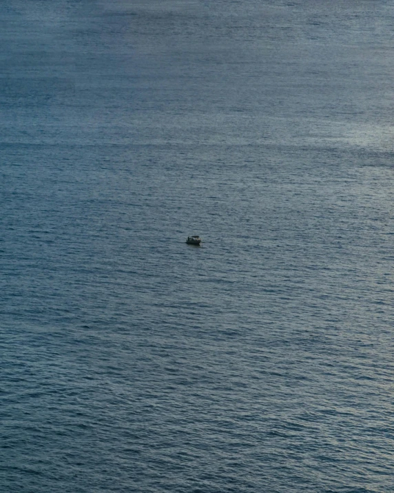 a boat floating on top of a large body of water, a picture, by Elsa Bleda, hurufiyya, overlooking the ocean, not a messenger from above, slightly pixelated, taken in the early 2020s