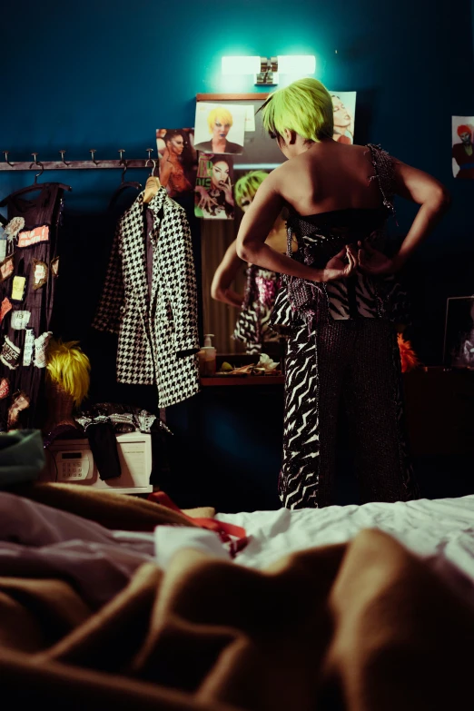 a woman standing in a bedroom next to a bed, inspired by Nan Goldin, happening, punk party, jingna zhang, colourful clothes, person in foreground