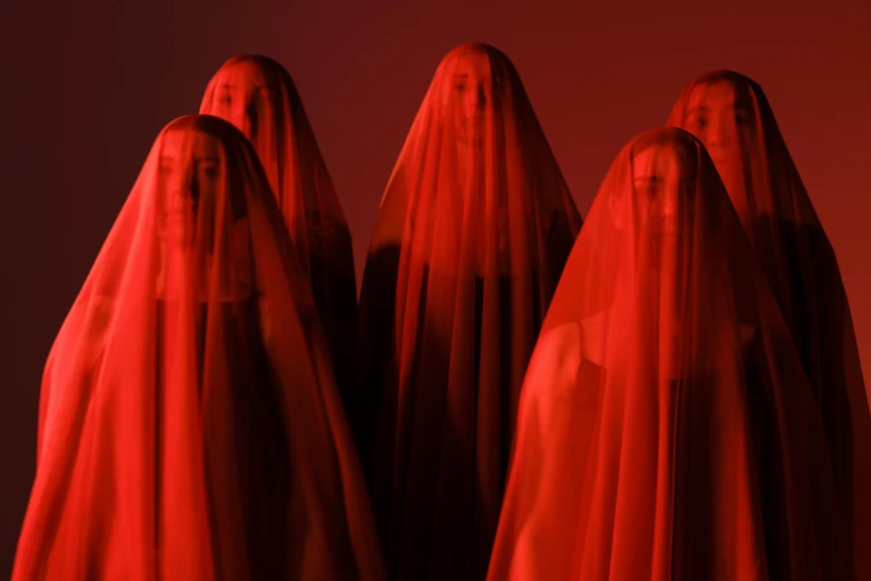 a group of people covered in red cloth, an album cover, inspired by Vanessa Beecroft, pexels contest winner, synthetism, levitating twin nuns, blood aura red light, agnes pelton, concert photo