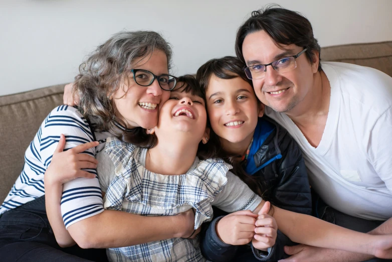 a group of people sitting on top of a couch, rebecca sugar, husband wife and son, portrait image, holding an epée