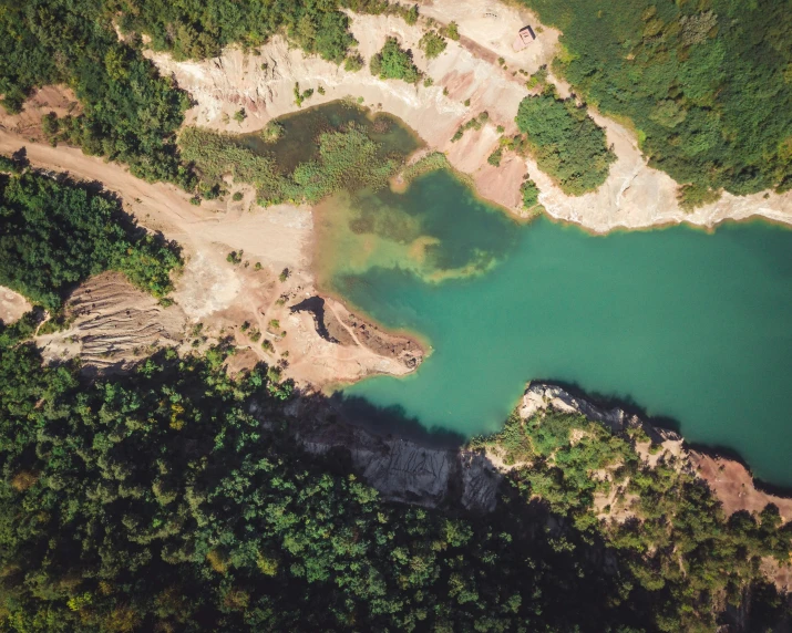 a large body of water surrounded by trees, by Elsa Bleda, pexels contest winner, hurufiyya, mining outpost, highly detailed and complex, landslides, thumbnail