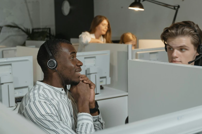 a man wearing headphones sitting in front of a computer, trending on pexels, hurufiyya, in meeting together, avatar image, cubicles, advertising photo