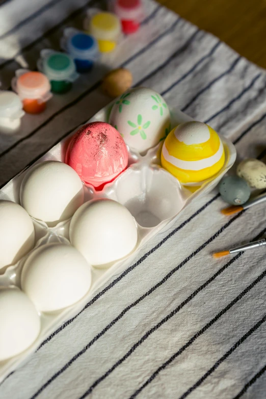 a tray of eggs sitting on top of a table, a photorealistic painting, unsplash, process art, candy decorations, white ceramic shapes, chalked, full product shot