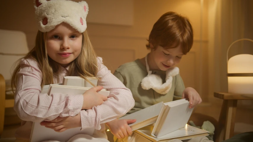 a couple of kids sitting on top of a bed, inspired by Elsa Beskow, arts and crafts movement, holding gift, product display photograph, soft evening lighting, wearing festive clothing