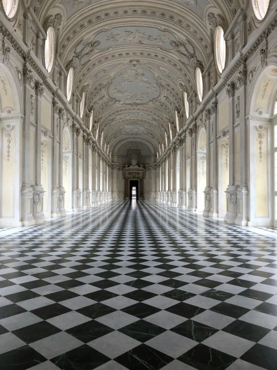 a long hallway with a black and white checkered floor, an album cover, inspired by Fra Bartolomeo, pexels contest winner, neoclassicism, 2 5 6 x 2 5 6 pixels, judy chicago, dark majestic ornate great hall, architectural digest