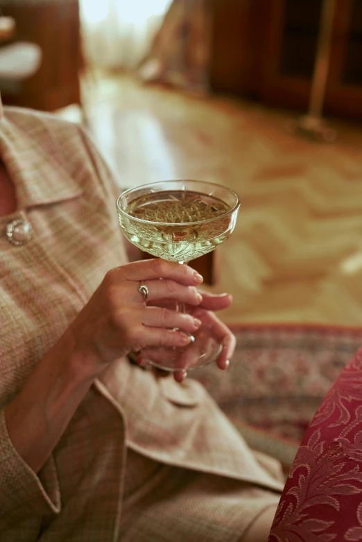 a woman sitting on a couch holding a wine glass, pexels, renaissance, portra 8 0 0 ”, low detail, top-down shot, older woman