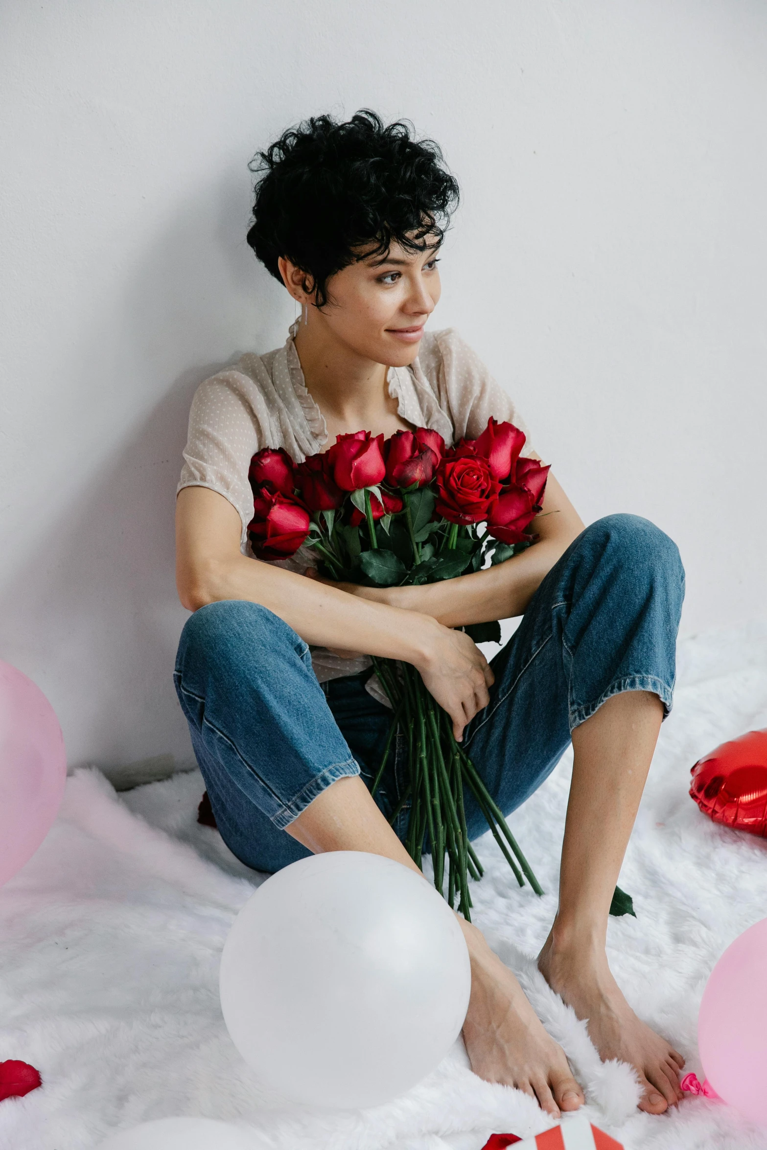 a man sitting on a bed holding a bunch of roses, by Winona Nelson, pexels contest winner, female camila mendes, balloons, beautiful androgynous girl, sarah andersen