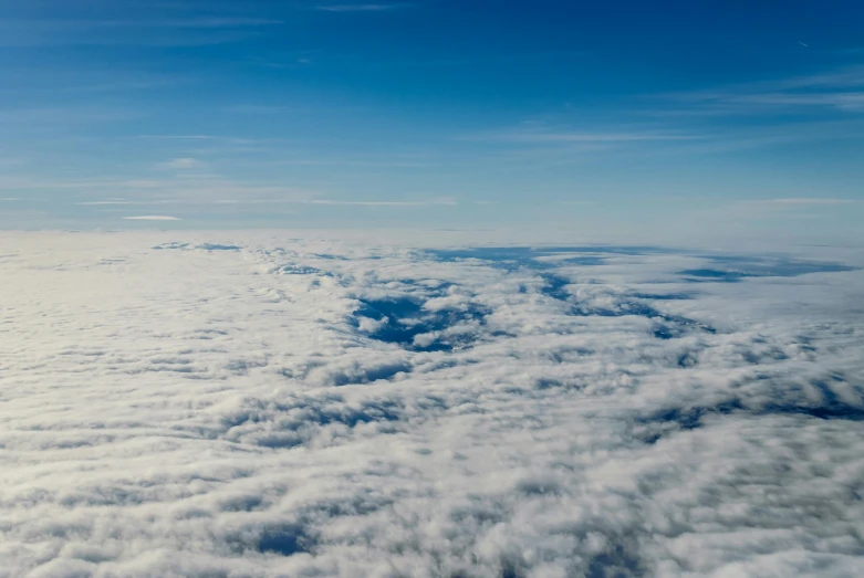 a view of the sky and clouds from an airplane, by Peter Churcher, pexels contest winner, surrealism, cloudless sky, low fog layer, subtitles, low angle 8k hd nature photo