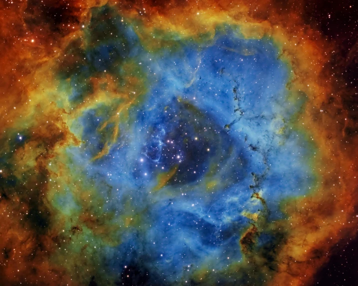 an image of a planetary object in the sky, a microscopic photo, flickr, space art, strong blue and orange colors, vast nebula, yellow, hexagonal shaped
