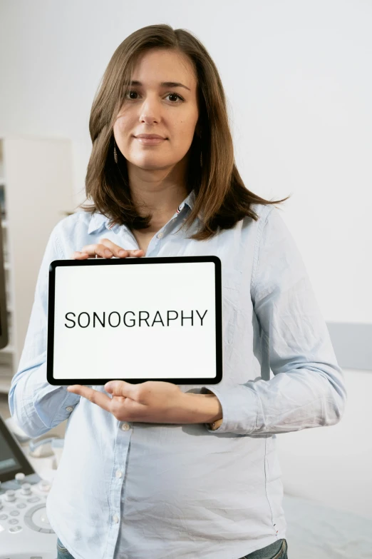 a woman holding a sign that says sonography, holography, sparsely populated, label, monochromatic, ortografico