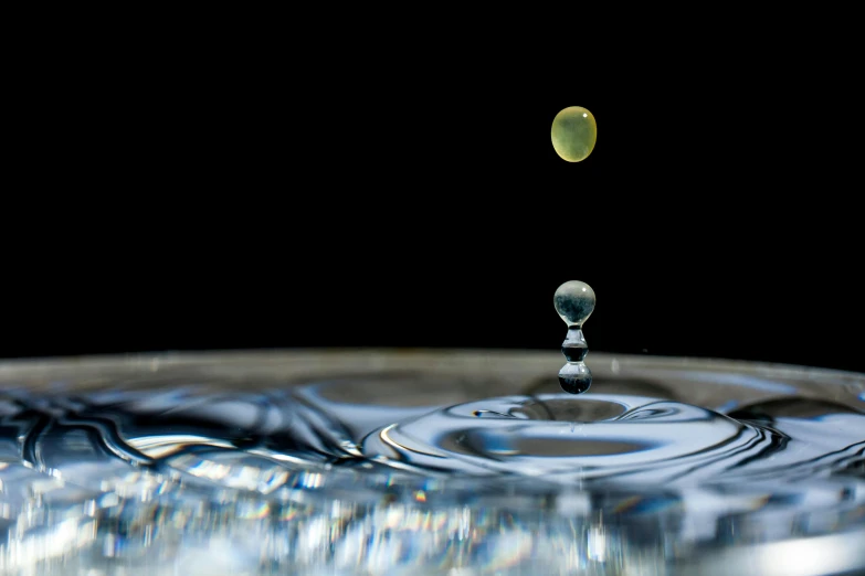 a drop of water falling into a bowl, by Jan Rustem, art photography, two planets colliding, orrery, medium close-up shot, photograph taken in 2 0 2 0