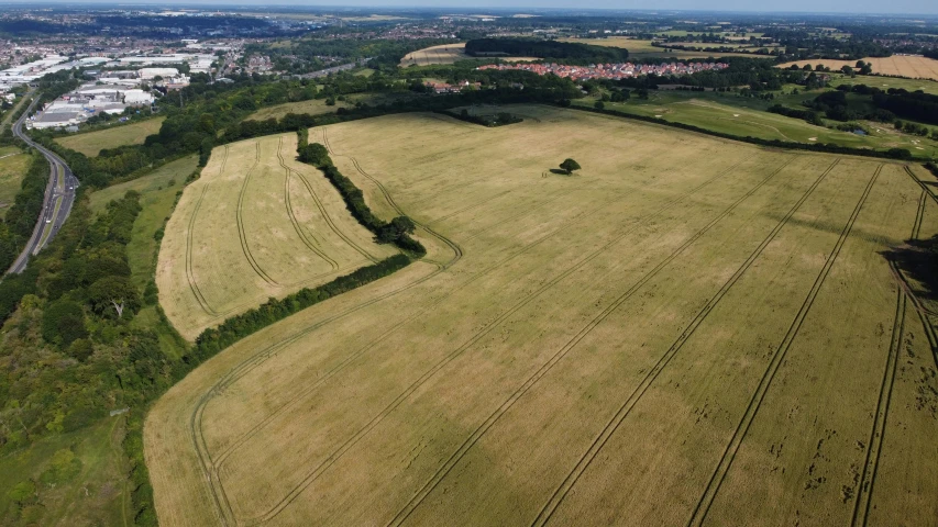 an aerial view of a large open field, by Julian Allen, english heritage, surrounding the city, 4k image”