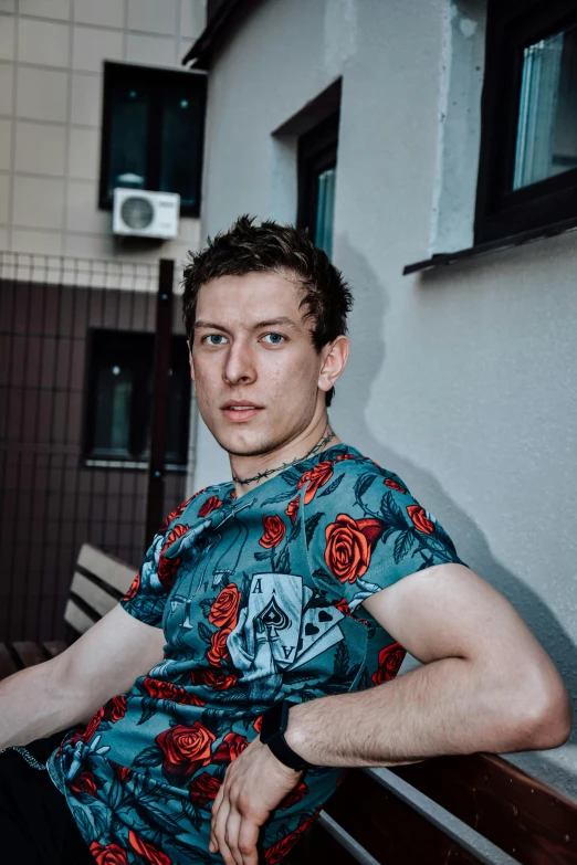 a man sitting on top of a wooden bench, an album cover, by Julia Pishtar, unsplash, renaissance, portrait of tom holland, low quality photo, alexey gurylev, street photo