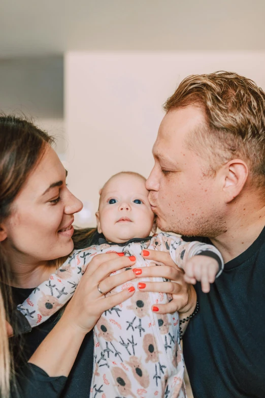a man kissing a woman while holding a baby, pexels contest winner, portrait of sanna marin, millaise and greg rutkowski, proud looking, profile image