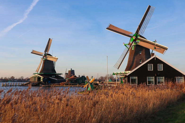 a couple of windmills next to a body of water, by Jan Tengnagel, pexels contest winner, canals, avatar image