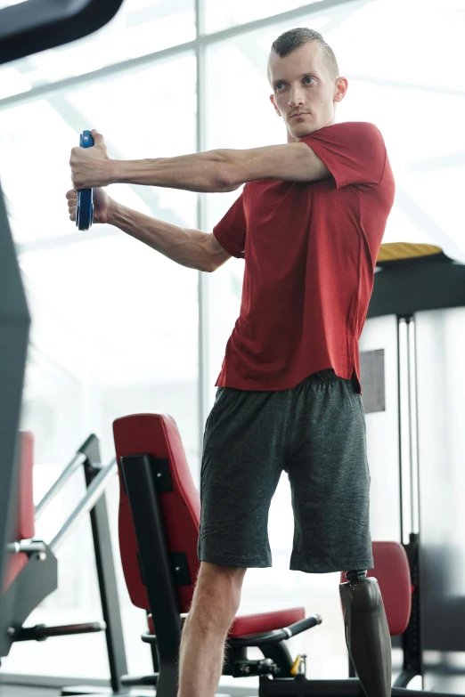 a man holding a baseball bat in a gym, a picture, red and grey only, square, half - body composition, thumbnail