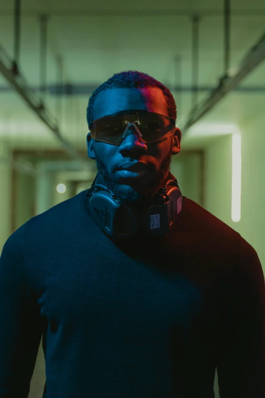 a man with headphones standing in a hallway, inspired by Terrell James, pexels contest winner, afrofuturism, idris elba as james bond, futuristic glasses lenses, portrait of a mech, moody dynamic lighting