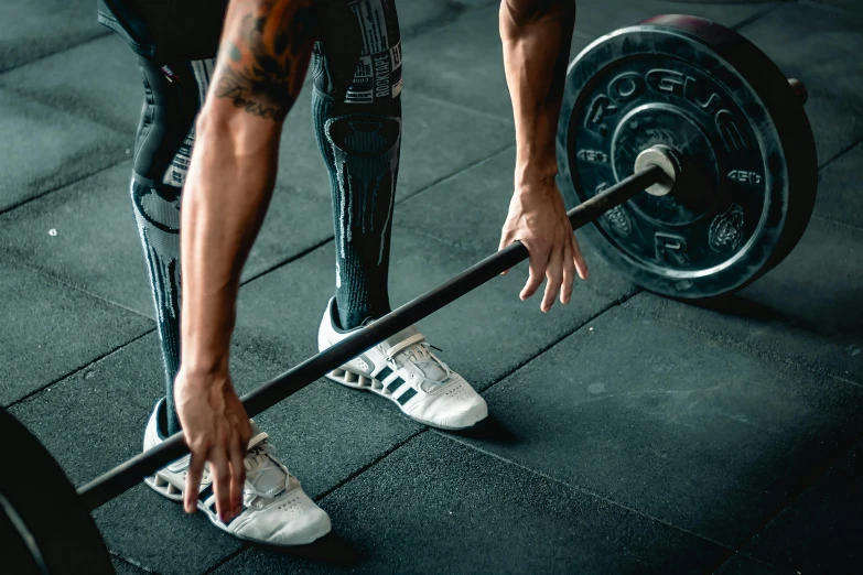 a close up of a person holding a barbell