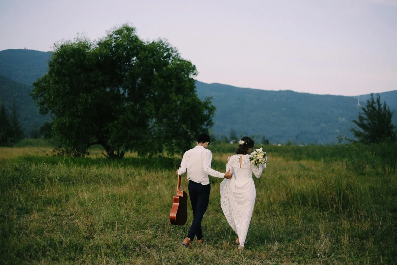 a man and a woman walking through a field, an album cover, pexels contest winner, happening, wedding, carrying a guitar, 268435456k film, sydney park