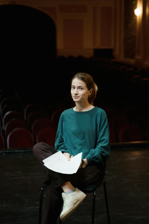 a woman sitting on a chair holding a piece of paper, multiple stories, young commoner, michael bair, teenager