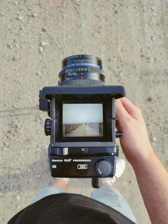 a close up of a person holding a camera, unsplash, photorealism, medium format color photography, lofi, hyperrealistic movie filmstill, hasselblad 500c