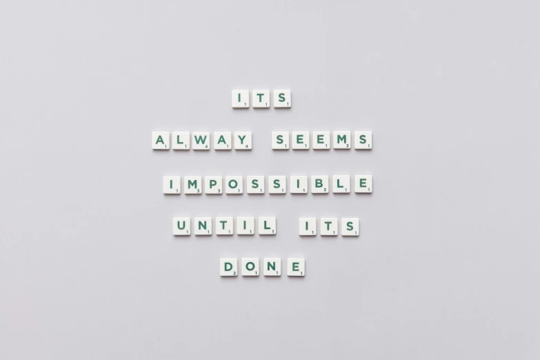 a sign that says it's always seems impossible until it's done, by Emma Andijewska, unsplash, minimalism, made of all white ceramic tiles, pixels, on a pale background, background image
