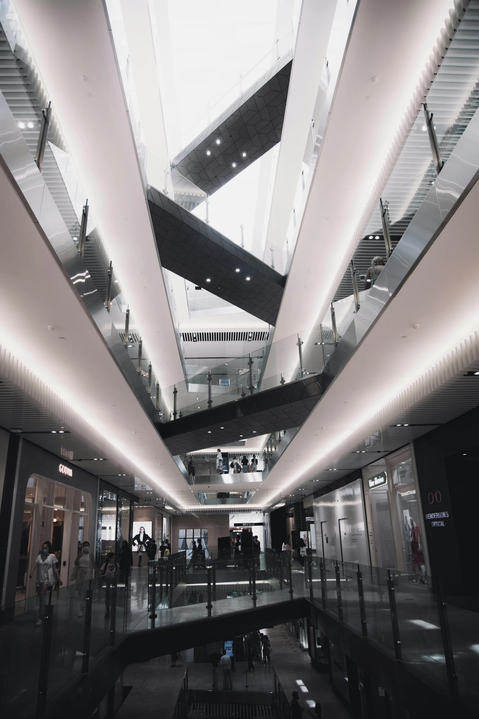 a group of people walking inside of a building, in a mall, mega structure, instagram story, but minimalist