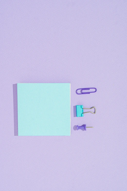 a piece of paper sitting on top of a table next to a pair of scissors, an album cover, trending on pexels, postminimalism, gradient cyan to purple, notebook, candy pastel, knolling