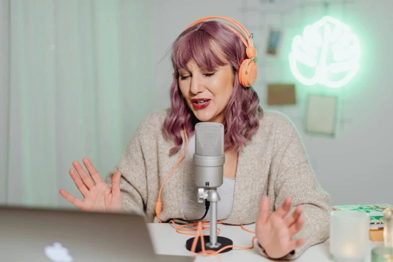 a woman sitting in front of a laptop wearing headphones, inspired by Joanna Carrington, trending on pexels, figuration libre, standing microphones, felicia day, green and purple studio lighting, on a canva