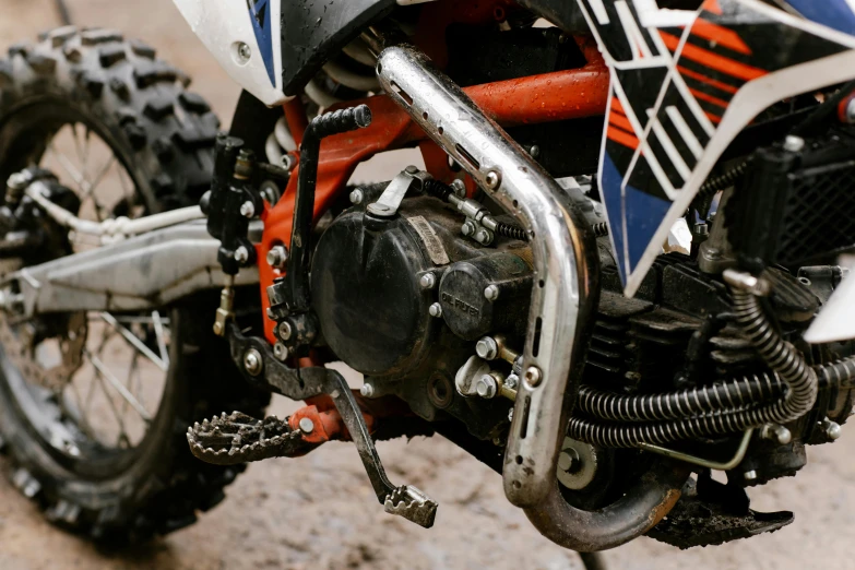 a close up of the front end of a dirt bike, unsplash, auto-destructive art, with pipes attached to it, profile image, 🚿🗝📝, pistons and bolts