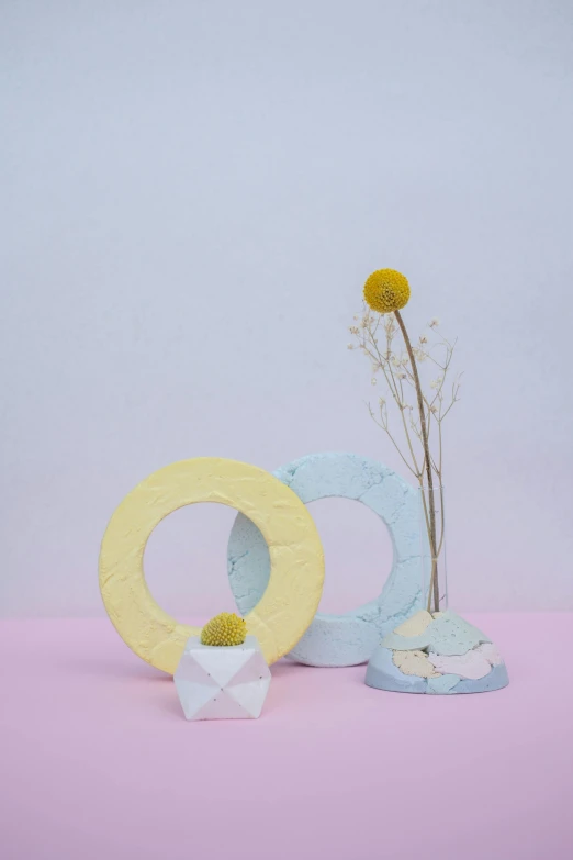 two vases sitting next to each other on a pink surface, shaped like torus ring, white and yellow scheme, pastelcolours, holly herndon origami statue
