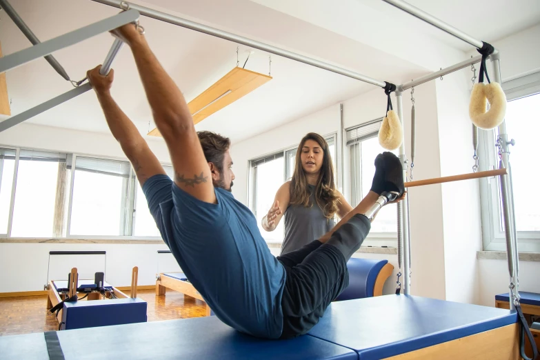 a man and a woman doing pilates in a gym, a picture, by Nina Hamnett, trending on unsplash, arabesque, square, sydney, extremely graphic, studio photo